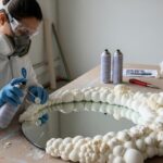 person making cloud mirror with foam