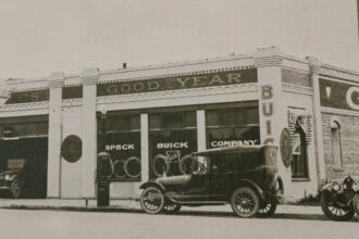 Historic Speck Buick Company dealership with vintage cars parked outside