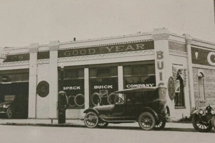 Historic Speck Buick Company dealership with vintage cars parked outside